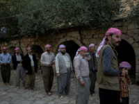 LALISH, IRAQ - NOVEMBER 11: Yazidi men line up before starting a religious ritual outside the holiest temple of the Yazidi faith while attending friday rituals on November 11, 2016 in Lalish, Iraq. Lalish is the site of the tomb of Sheikh Adi ibn Musafir, the central figure of the Yazidi faith. In 2014 thousands of Yazidis fled to the villages of Lalish and Shekhan after ISIS took control of Sinjar and other Yazidi populated towns. Many Yazidi resettled in Mosul and Bashiqah but were forced to flee again when ISIS took control of the cities. The liberation of Bashiqah four days ago by the Iraqi army and the continuing Mosul offensive has given many Yazidi 's hope they will soon be able to return home. (Photo by Chris McGrath/Getty Images) Chris McGrath / GETTY IMAGES EUROPE / Getty Images/AFP