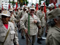 Members of the Bolivarian Militia take part in a parade in the framework of the seventh anniversary of the force, in front of the Miraflores presidential palace in Caracas on April 17, 2017. Venezuela's defence minister on Monday declared the army's loyalty to Maduro, who ordered troops into the streets ahead of a major protest by opponents trying to oust him. Venezuela is bracing for what Maduro's opponents vow will be the 'mother of all protests' Wednesday, after two weeks of violent demos against moves by the leftist leader and his allies to tighten their grip on power. / AFP PHOTO / Federico PARRA (Photo credit should read FEDERICO PARRA/AFP/Getty Images)