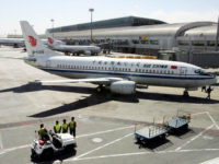 Chinese workers stand in front of an Air China Boeing B737 aircraft at Beijing Airport March 23, 2005. REUTERS/Claro Cortes IV