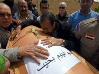 Men mourn over the coffin of one of the victims of the blast at the Coptic Christian Saint Mark's church in Alexandria the previous day during a funeral procession at the Monastery of Marmina in the city of Borg El-Arab, east of Alexandria on April 10, 2017. Egypt prepared to impose a state of emergency after jihadist bombings killed dozens at two churches in the deadliest attacks in recent memory on the country's Coptic Christian minority. / AFP PHOTO / MOHAMED EL-SHAHED (Photo credit should read MOHAMED EL-SHAHED/AFP/Getty Images)