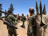 Fighters of the Syria Democratic Forces (SDF) carry their weapons as they walk in the western rural area of Manbij, in Aleppo Governorate, Syria, June 13, 2016. REUTERS/Rodi Said