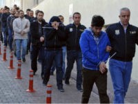 Police officers escort people, arrested because of suspected links to U.S.-based cleric Fethullah Gulen, in Kayseri, Turkey, Wednesday, April 26, 2017. Police launched simultaneous operations across the country on Wednesday, detaining hundreds of people with suspected links to U.S.-based cleric Fethullah Gulen. The suspects are allegedly Gulen operatives who directed followers within the police force. (Olay Duzgun/DHA-Depo Photos via AP)