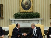 Translators watch as Egypt's President Abdel Fattah al-Sisi (L) and US President Donald Trump shake hands in the Oval Office before a meeting at the White House April 3, 2017 in Washington, DC
