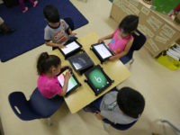 FILE - In this April 2, 2014 file photo, Pre-K students use electronic tablets at the South Education Center in San Antonio. As Gov. Rick Perry wraps up a record 14 years on the job, Republican Greg Abbott and Democrat Wendy Davis are both vowing to make public schools a top-line agenda if elected in November. Following through could make public schools a signature issue for a Texas governor as it was under George W. Bush, before he left for the White House and used the state’s testing system as the framework for No Child Left Behind. (AP Photo/Eric Gay, File)