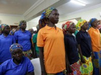 In this Monday, May 8, 2017 file photo, Chibok schoolgirls, recently freed from Nigeria extremist captivity, are photographed in Abuja, Nigeria. One of the Chibok schoolgirls kidnapped by Boko Haram in 2014 and who had the opportunity to be released on Saturday chose to stay with her husband, the spokesman for Nigeria’s president said Tuesday, May 9. Presidential spokesman Garba Shehu said officials originally had been negotiating for the release of 83 girls, but one said she wanted to remain. (AP Photo/Sunday Alamba, File )