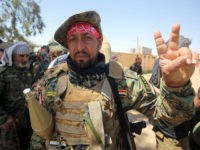 Members of the Iraqi pro-government Hashed al-Shaabi (Popular Mobilisation) paramilitary forces gesture from the modern town of Hatra, near the eponymous UNESCO-listed ancient city, southwest of the northern city of Mosul, on April 28, 2017. Iraqi forces retook the town of Hatra, southwest of Mosul, on the third day of an operation that saw them wrest back the archeological site from the Islamic State group. The ancient city is one of the heritage jewels of Iraq and was damaged by IS after they took over large parts of the country three years ago. / AFP PHOTO / AHMAD AL-RUBAYE (Photo credit should read AHMAD AL-RUBAYE/AFP/Getty Images)