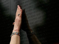 Ann Pruett reaches to touch the name of her husband, Richard Monroe Pruett, which was added to the Vietnam Veterans Memorial May 3, 2007 in Washington, DC. Pruett's husband, Richard Monroe Pruett, who died in 2005 from wounds sustained in Vietnam, was one of three men whose name was added to the Wall. The additions bring the number of names on The Wall to 58,256 men and women who were killed or remain missing in action. The additional names that were added were Joseph Krywicki and Alvin Stiverson. (Photo by Win McNamee/Getty Images)
