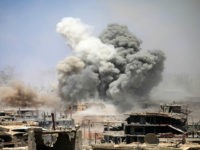 TOPSHOT - Smoke rises from buildings following a reported air strike on a rebel-held area in the southern Syrian city of Daraa, on May 22, 2017. / AFP PHOTO / Mohamad ABAZEED (Photo credit should read MOHAMAD ABAZEED/AFP/Getty Images)
