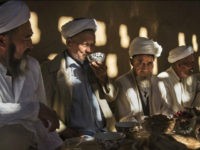 TURPAN, CHINA - SEPTEMBER 13: (CHINA OUT) Uyghur men gather for a holiday meal during the Corban Festival on September 13, 2016 in Turpan County, in the far western Xinjiang province, China. The Corban festival, known to Muslims worldwide as Eid al-Adha or 'feast of the sacrifice', is celebrated by ethnic Uyghurs across Xinjiang, the far-western region of China bordering Central Asia that is home to roughly half of the country's 23 million Muslims. The festival, considered the most important of the year, involves religious rites and visits to the graves of relatives, as well as sharing meals with family. Although Islam is a 'recognized' religion in the constitution of officially atheist China, ethnic Uyghurs are subjected to restrictions on religious and cultural practices that are imposed by China's Communist Party. Ethnic tensions have fueled violence that Chinese authorities point to as justification for the restrictions. (Photo by Kevin Frayer/Getty Images)