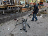 A man clears debris from the aftermath of a massive bombing in central Baghdad, Iraq, Monday, May 30, 2017. The bomb exploded outside a popular ice cream shop in the Karrada neighborhood of Baghdad just after midnight on Monday, killing and wounding dozens of civilians, hospital and police officials said. (AP Photo/Karim Kadim)