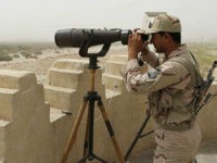 An Iranian border guard looks through a pair of binoculars to monitor a border area for drug trafficking activities on July 19, 2011, in Milak, southeastern Iran. The region borders both Aghanistan and Pakistan, and sits on a major trafficking route. The UN office on drugs and crime (UNODC) today praised Iran's anti-narcotics effort, urging other countries to follow its example, as its chief travelled to Tehran for a three-day visit. UNODC director Yury Fedotov also praised the cooperation between Afghanistan, Iran and Pakistan as part of a 'Triangular Initiative,' which has led to the seizure of several tons of drugs in joint operations. Some 89 percent of global opium seizures and 41 percent of heroin and morphine seizures occur in Iran, according to the UNODC. AFP PHOTO/ATTA KENARE (Photo credit should read ATTA KENARE/AFP/Getty Images)