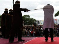 BANDA ACEH, INDONESIA - MAY 23: An Indonesian man gets caning in public from an executor known as 'algojo' for having gay sex, which is against Sharia law at Syuhada mosque on May 23, 2017 in Banda Aceh, Indonesia. The two young gay men, aged 20 and 23, were caned 85 times each in the Indonesian province of Aceh during a public ceremony after being caught having sex last week. It was the first time gay men have been caned under Sharia law as gay sex is not illegal in most of Indonesia except for Aceh, which is the only province which exercises Islamic law. The punishment came a day after the police arrested 141 men at a sauna in the capital Jakarta on Monday due to suspicion of having a gay sex party, the latest crackdown on homosexuality in the country. PHOTOGRAPH BY Riau Images / Barcroft Images London-T:+44 207 033 1031 E:hello@barcroftmedia.com - New York-T:+1 212 796 2458 E:hello@barcroftusa.com - New Delhi-T:+91 11 4053 2429 E:hello@barcroftindia.com www.barcroftimages.com (Photo credit should read Riau Images / Barcroft Images / Barcroft Media via Getty Images)