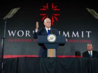 Vice President Mike Pence addresses the World Summit in Defense of Persecuted Christians as Franklin Graham watches, Thursday, May 11, 2017, in Washington. The summit is hosted by Franklin Graham, and the Billy Graham Evangelistic Association. (AP Photo/Cliff Owen)