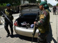 Philippine policemen check a car boot of a resident fleeing from Marawi city, where gunmen who had declared allegiance to the Islamic State group rampaged through the southern city, at a checkpoint in Iligan City, in southern island of Mindanao on May 24, 2017. Philippine President Rodrigo Duterte warned that martial law would be 'harsh' and like a dictatorship, after imposing military rule in the south of the country to combat Islamist militants. / AFP PHOTO / TED ALJIBE (Photo credit should read TED ALJIBE/AFP/Getty Images)