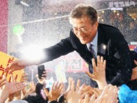 File photo taken May 5, 2017, shows Moon Jae In of the liberal Democratic Party of Korea greeting supporters in the rain in Busan during campaigning in South Korea's presidential election. Voting concluded on May 9. (Kyodo) ==Kyodo (Photo by Kyodo News via Getty Images)