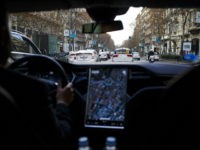 A Tesla Motors Inc. Model S electric automobile, operated Uber Technologies Inc., drives through traffic, in Madrid, Spain, on Friday, Jan. 13, 2017. Ride-hailing service Uber Technologies has launched its first electric car taxi service in Madrid, operating a fleet of Tesla Model S electric vehicles. Photographer: Angel Navarrete/Bloomberg via Getty Images