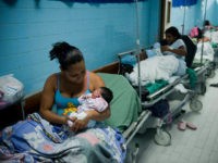 TO GO WITH AFP STORY BY LISSY DE ABREU Mothers and their newborns rest in a maternity center in Caracas, on December 15, 2011. According to the World Health Organization, Venezuela holds the first place in South America in cases of early pregnancy, with about 1,500 children born daily from teenage mothers aged between 12 and 19 years. AFP PHOTO / Leo RAMIREZ (Photo credit should read LEO RAMIREZ/AFP/Getty Images)