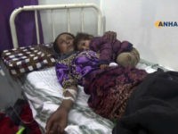 This frame grab from video provided by the Hawar News Agency, shows a woman wounded in an attack by the Islamic State group, in bed at a clinic in Hasakeh province, Syria, Tuesday, May 2, 2017. Islamic State militants staged a surprise attack early Tuesday at a crossing frequently used by Iraqi and Syrian civilians seeking safety in northeastern Syria, killing at least 37 people, most of them civilians who had fled fighting in areas held by the extremist group, Kurdish officials and activists said. (Hawar News Agency, via AP)