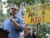 Mike Cernovich, left, a right-wing author and attorney, speaks during a rally outside the White House in Washington, Sunday, June 25, 2017. Cernovich was one of many speakers at the "Rally Against Political Violence," that was to condemn the attack on Republican congressmen during their June 14 baseball practice in Virginia and the "depictions of gruesome displays of brutality against sitting U.S. national leaders." (AP Photo/Susan Walsh)