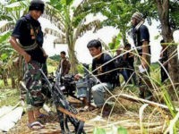 In this photo taken Tuesday, Aug. 16, 2011, followers of rebel leader Ameril Umbra Kato, the commander of Bangsamoro Islamic Freedom Fighters (BIFF) , the breakaway faction of the largest Muslim rebel group, rest inside the rebel stronghold in Maguindanao province in southern Philippines. On Wednesday, Aug. 17, 2011, the largest Muslim rebel group in the Philippines, the Moro Islamic Liberation Front (MILF) has given the radical Kato, with hundreds of fighters, a final warning to stop a mutiny or face expulsion, which would expose his breakaway force to possible military assaults. (AP Photo/Nickee Butlangan)