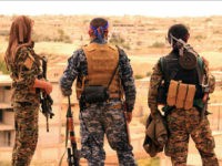 FILE -- This April 30, 2017, file photo, provided by the Syrian Democratic Forces (SDF), shows fighters from the SDF looking toward the northern town of Tabqa, Syria. U.S.-backed Syrian forces have launched their attack on the Islamic State group's de facto capital of Raqqa, in northern Syria, just as the jihadist group is making its last stand in Mosul in neighboring Iraq.. (Syrian Democratic Forces, via AP, File)