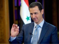 FILE - In this Feb. 10, 2015, file photo released by the Syrian official news agency SANA, Syrian President Bashar Assad gives an interview with the BBC in Damascus, Syria. On Wednesday, March 30, 2016, Assad said in an interview with Sputnik, a Russian state news agency, that Syria needs a national unity government that would secure the transition to a new constitution, rejecting the "transitional body" demanded by the opposition, which wants him to step down. Assad said Syrian refugees will begin returning home when they see hope for improvement, adding that one of the main causes of migration is Western sanctions against Syria. (SANA via AP, File)