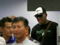 Former NBA basketball star Dennis Rodman, right, is seen in a security queue at Beijing's International Airport's terminal 2 on Tuesday, June 13, 2017, in Beijing, China. North Korea is expecting another visit by former NBA bad boy Rodman on Tuesday in what would be his first to the country since President Donald Trump took office. (AP Photo/Wong Maye-E)