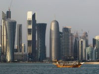 FILE - In this Thursday Jan. 6, 2011 file photo, a traditional dhow floats in the Corniche Bay of Doha, Qatar, with tall buildings of the financial district in the background. Qatar, now facing a diplomatic crisis with other Arab nations, is a small country with a big history of turmoil and coups as it became one of the world's top suppliers of natural gas and now plans to host the 2022 FIFA World Cup. (AP Photo/Saurabh Das, File)