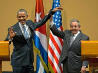 FILE - In this March 21, 2016 file photo, Cuban President Raul Castro, right, lifts up the arm of U.S. President Barack Obama, at the conclusion of their joint news conference at the Palace of the Revolution, in Havana, Cuba. Next year will likely be Castro’s toughest year in office since he took power in 2006, as the 85-year-old general faces a possible economic recession alongside a hostile new U.S. administration promising to undo measures that gave many Cubans expectations of a better future. (AP Photo/Ramon Espinosa, File)