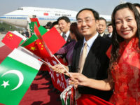 Chinese nationals carry Pakistani and Chinese flags during Chinese President Hu Jintao arrival at Allama Iqbal International airport in Lahore, 25 November 2006. Chinese President Hu Jintao received a warm welcome in the eastern Pakistani city of Lahore where he arrived for cultural and business visits after concluding a free trade deal and pledging to boost strategic ties. a reception hosted by the citizens of Lahore at the scenic Mughal-era Shalimar gardens. AFP PHOTO/Arif ALI Arif Ali / AFP