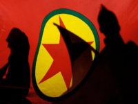 ** FILE ** In this Nov. 12, 2007 file picture, Kurdish demonstrators are silhouetted by a Kurdistan Workers' Party (PKK) flag during a protest in the Cypriot capital of Nicosia. Kurdish rebels have kidnapped three German climbers on Mount Ararat, the governor of a province in eastern Turkey said Wednesday July 9, 2008. A Kurdish news agency is quoting Kurdish rebels as saying they won't free three kidnapped Germans until Berlin renounces its crackdown on the guerrilla group. (AP Photo/Petros Karadjias)