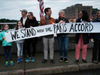 WESTPORT, CT - JUNE 04: Dozens of Connecticut residents converge along a bridge at a vigil and rally for the environment and against President Donald Trump's recent decision to withdraw the United States from the Paris climate accord on June 4, 2017 in Westport, Connecticut. Close to 80 people attended the evening event where critics of the president's environmental policies held candles and sang songs. Trump's decision last week to pull out of the Paris climate agreement has outraged both world leaders and citizens alike. (Photo by Spencer Platt/Getty Images)