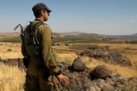 A Israeli soldier on patrol near the border with Syria after projectiles fired from the war-torn country hit the Israeli occupied Golan Heights on June 24