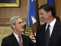 FILE - In this Sept. 4, 2013, file photo, then-incoming FBI Director James Comey talks with outgoing FBI Director Robert Mueller before Comey was officially sworn in at the Justice Department in Washington. Mueller, the somber-faced and demanding FBI director who led the bureau through the Sept. 11 attacks, and Comey, his more approachable and outwardly affable successor, may be poles apart stylistically but both command a wealth of respect in the law enforcement and legal community. (AP Photo/Susan Walsh, File)