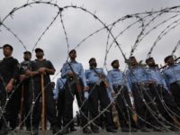 Pakistani police officers stand guard behind barbed wire to stop Shiite Muslims advancing toward the presidency, during a rally to condemn last weeks twin bombings in Parachinar, the center of Kurram region, in Islamabad, Pakistan, Wednesday, June 28, 2017. Battered by bombings that have killed scores of people, Pakistan's tribal Shiite Muslims took their protests to the Pakistani capital while in Pakistan's Kurram tribal region, where Shiites dominate. (AP Photo/Anjum Naveed)