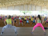 Zumba Fitness instructors Andrea Ceballos, left, and Michelle Donoso, right, lead a crowd in a workout during a Fitness Dance Party, Saturday, July 25, 2015, at Tropical Park in Miami. The event promoted health and fitness activities as part of Miami-Dade County's Park and Recreation Month. (AP Photo/Wilfredo Lee)