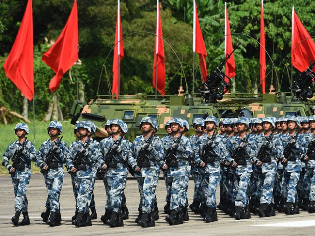 Members of Chinese People's Liberation Army based at the Hong Kong garrison march following Chinese President Xi Jinping's review in Hong Kong on June 30, 2017. Xi toured a garrison of Hong Kong's People's Liberation Army garrison as part of a landmark visit to the politically divided city. Anthony WALLACE / AFP