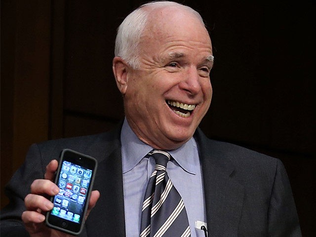WASHINGTON, DC - SEPTEMBER 04: U.S. Sen. John McCain (R-AZ) holds up his smart phone to show he is not playing poker before the Senate Foreign Relations Committee vote on a resolution on Syria on Capitol Hill September 4, 2013 in Washington, DC. The Senate Foreign Relations Committee voted to authorize U.S. President Barack Obama to use limited force against Syria after adopting amendments from U.S. Sen. John McCain (R-NV). (Photo by Mark Wilson/Getty Images)