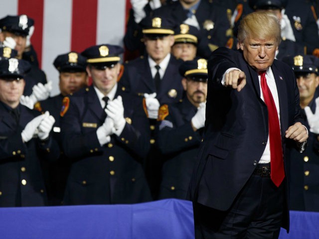 President Donald Trump points to the crowd after speaking to law enforcement officials on the street gang MS-13, Friday, July 28, 2017, in Brentwood, N.Y. (Evan Vucci/Associated Press)