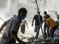 DAMASCUS, SYRIA - JULY 13: Syrians inspect a debris after an Assad Regime's fighter jet fired a vacuum bomb and hit residential areas at the Ein Terma town of Eastern Ghouta, which is a de-conflict zone under control of opponents, in Damascus, Syria on July 13, 2017. (Photo by Ala Muhammed/Anadolu Agency/Getty Images)