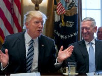 U.S. President Donald trump speaks while James Mattis, U.S. secretary of defense, right, laughs during a meeting with members of the Cabinet at the White House in Washington, D.C., U.S, on Monday, March 13, 2017. Trump said it could take several years for health insurance prices to start to drop under an Obamacare replacement plan he is promoting, creating a rocky transition period that could pose a risk for members of Congress up for re-election next year and Trump's own bid for a second term in 2020. Photographer: Michael Reynolds/Pool via Bloomberg