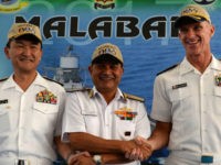 Japanese Rear Admiral Hiroshi Yamamura (L), US Rear Admiral William Byrne (R) and HCS Bisht, vice admiral of the Indian Navy, pose for photographers during the inauguration of joint naval exercises with the United States and India in Chennai on July 10, 2017. India began holding naval exercises with the United States and Japan off its south coast on July 10, seeking to forge closer military ties to counter growing Chinese influence in the region. / AFP PHOTO / ARUN SANKAR (Photo credit should read ARUN SANKAR/AFP/Getty Images)