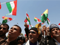 Iraqi Kurdish protesters wave flags of their autonomous Kurdistan region during a demonstration to claim for its independence on July 3, 2014 outside the Kurdistan parliament building in Arbil, in northern Iraq. The Kurdish leader, Massud Barzani asked its parliament to start organizing a referendum on independence. AFP PHOTO / SAFIN HAMED (Photo credit should read SAFIN HAMED/AFP/Getty Images)
