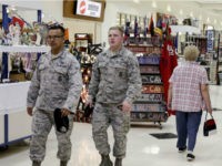 In this May 24, 2017, photo, members of the military and civilians with shopping privileges walk among stores at the Exchange, at Offutt Air Force Base, Neb. Starting in fall 2017, all honorably discharged veterans will be eligible to shop tax-free online at the Exchange with the same discounts they enjoyed at stores on base while they were in the military. It's the latest way in which the Army & Air Force Exchange Service is trying to keep its customers as the armed forces shrink and airmen and soldiers buy more for delivery. (AP Photo/Nati Harnik)