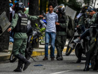 Members of the National Guard arrest an opposition activists during clashes following a march towards the Supreme Court of Justice (TSJ) in an offensive against President Maduro and his call for Constituent Assembly in Caracas on July 22, 2017. The Legislative power, controlled by the opposition, appointed Friday a parallel supreme court in a public session claiming the TSJ judges had been illegally appointed by the parliaments former pro-government majority. / AFP PHOTO / JUAN BARRETO (Photo credit should read JUAN BARRETO/AFP/Getty Images)