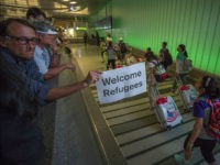 LOS ANGELES, CA - JUNE 29: John Wider carries a welcome sign near arriving international travelers on the first day of the the partial reinstatement of the Trump travel ban, temporarily barring travelers from six Muslim-majority nations from entering the U.S., at Los Angeles International Airport (LAX) on June 29, 2017 in Los Angeles, California. Under a Supreme Court order, foreigners who do not have a so-called 'bona fide relationship' with a person or entity in the United States can be banned. The ban effects travelers from Iran, Libya, Somalia, Sudan, Syria and Yemen. (Photo by David McNew/Getty Images)