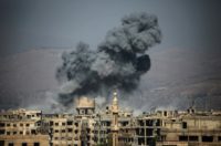 Smoke rises from buildings following a reported air strike on the rebel-held town of Ain Terma, in Syria's eastern Ghouta area, on July 7, 2017