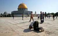 performs a prayer in gratitude to God near the Dome of the Rock in the Haram al-Sharif compound, known to Jews as the Temple Mount, in the Old City of Jerusalem on July 27, 2017, as Palestinians ended an almost two-week boycott