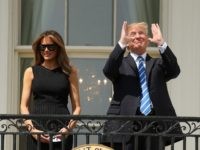 President Donald Trump, accompanied by first lady Melania Trump, gestures at the White House in Washington, Monday, Aug. 21, 2017, as they viewed the solar eclipse. (AP Andrew Harnik)