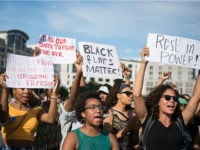 A protestor holds up a sign reading 'Black Lives Matter' during a demonstration in Berlin, on July 10, 2016 with the motto 'Black Lives Matter - No Justice = No Peace' as protest over the deaths of two black men at the hands of police last week. / AFP / dpa / Wolfram Kastl / Germany OUT (Photo credit should read WOLFRAM KASTL/AFP/Getty Images)